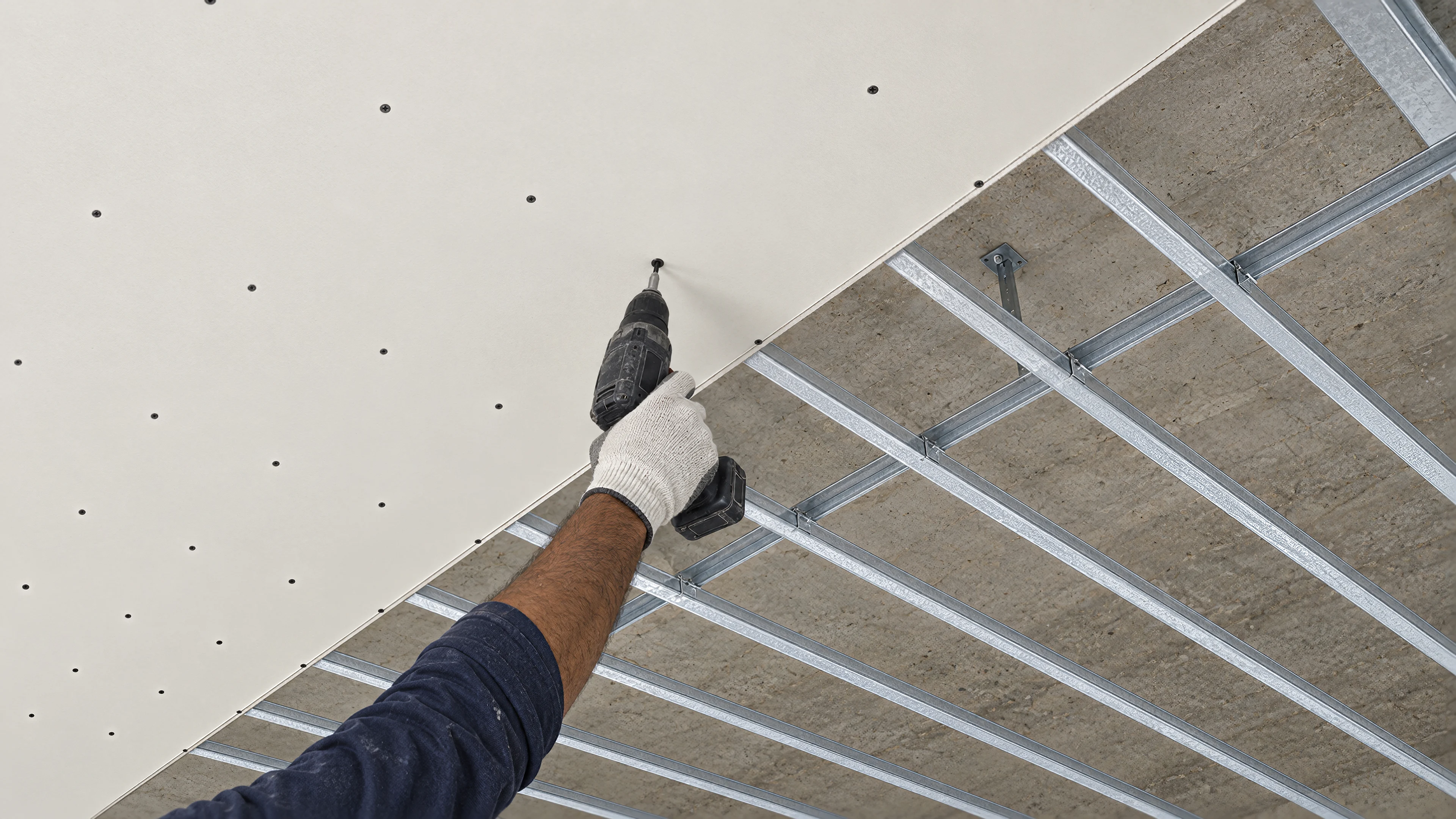 A board is screwed to the ceiling sections of the frame
